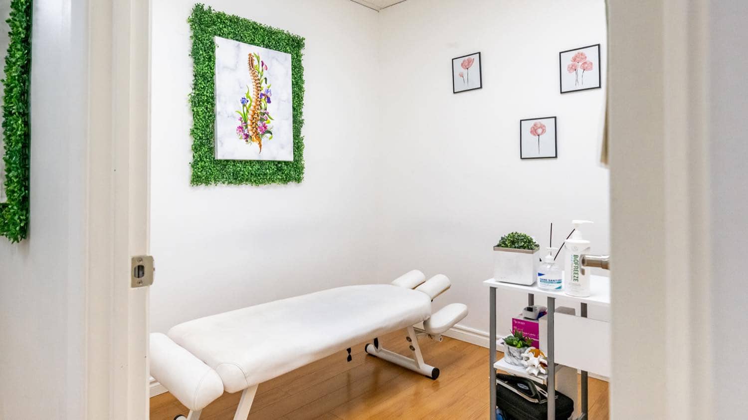 A chiropractic treatment room at iBODY with an adjustment table